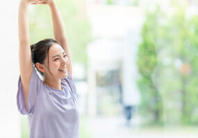 Young asian woman doing stretch. Health care. Body care.